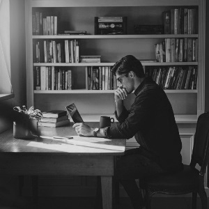 Person in their home office paying attention to content on their laptop screen